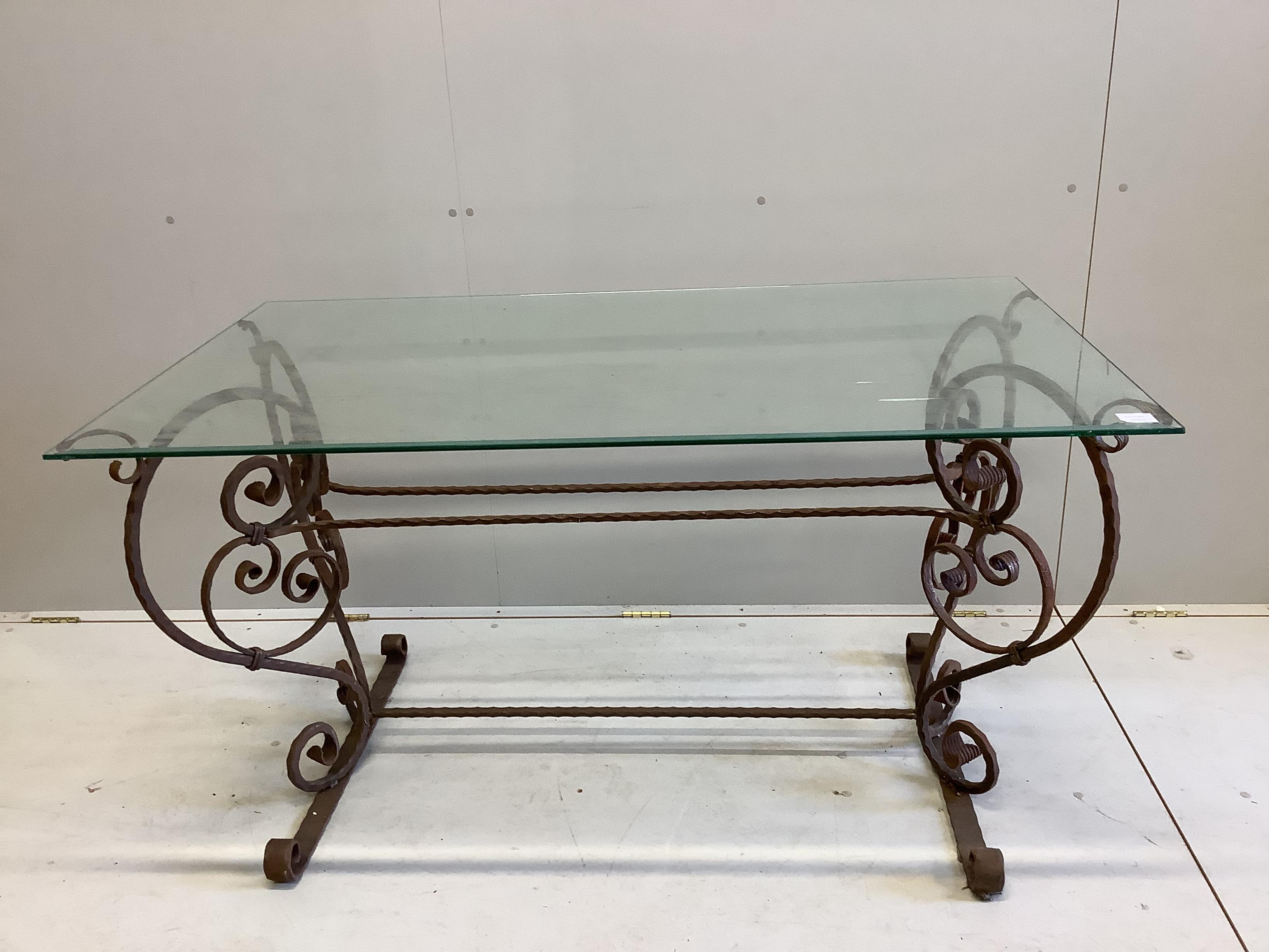 A rectangular wrought iron glass top table, width 140cm, depth 80cm, height 76cm